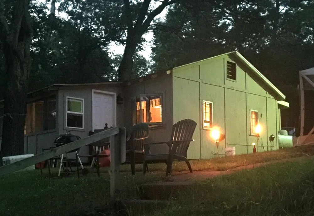Cozy resort cabin glowing at dusk